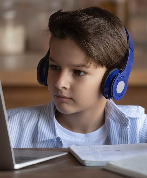 Image of kid with blue headphones on computer